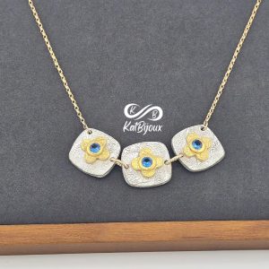 necklace-silver-gold-blue-spinel-cushion Silver and gold cushion necklace with blue spinels
