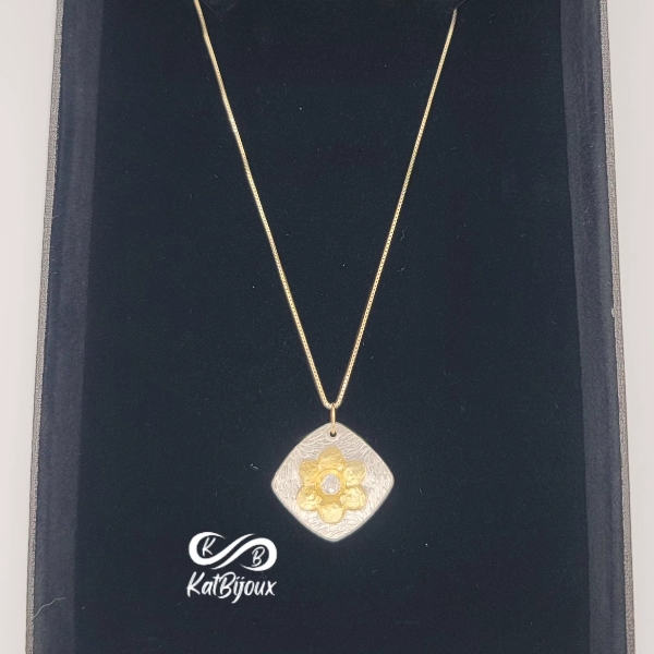 Silver and 24k gold flower pendant with stone