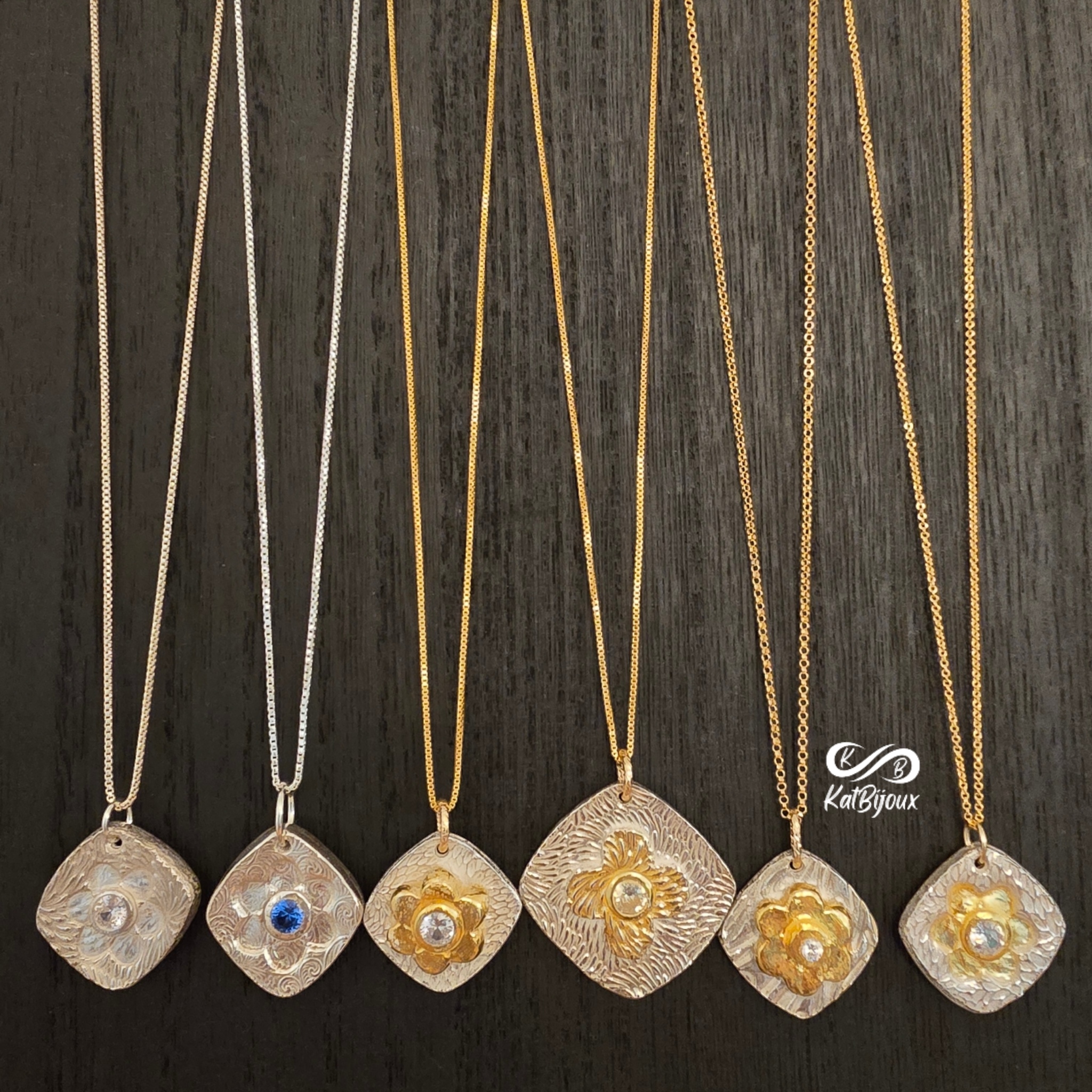 Assortment of silver and 24k gold flower pendants